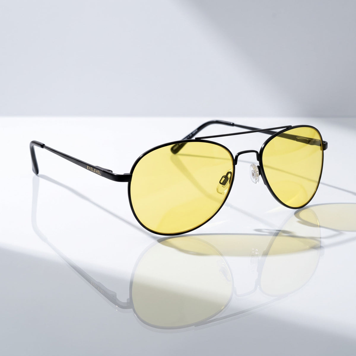 Eyelevel-UK Night Driver 1 sunglasses with black aviator frames and yellow lenses for low-light driving conditions.