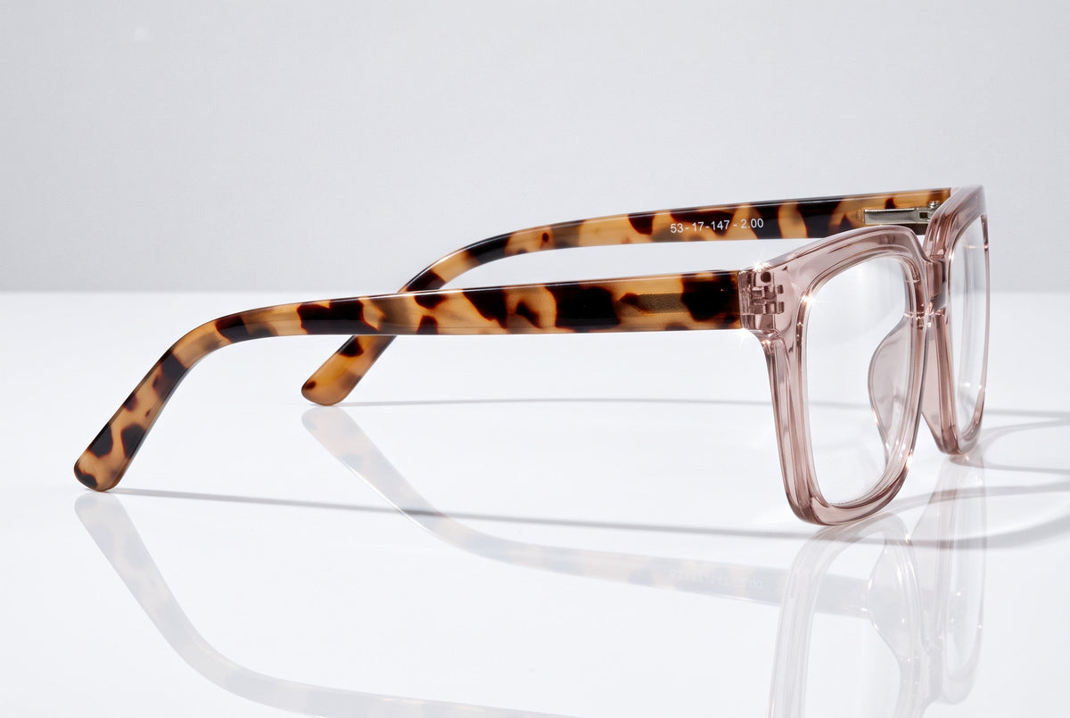 Eyelevel-UK Cayman reading glasses with pale-pink squared frames and tortoiseshell-patterned arms on a white surface.