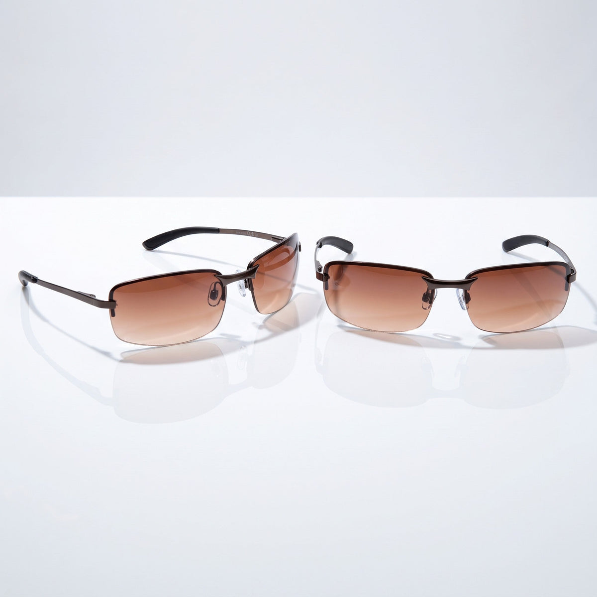 Eyelevel-UK Daytona driving sunglasses with high density brown gradient lenses and gunmetal frames on a white surface.