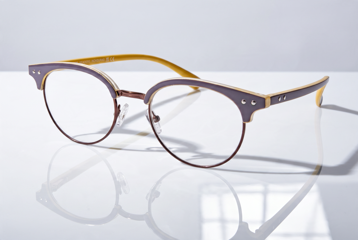 Eyelevel-UK Honduras reading glasses with a two-tone oval frame in brown and mustard yellow on a reflective surface.