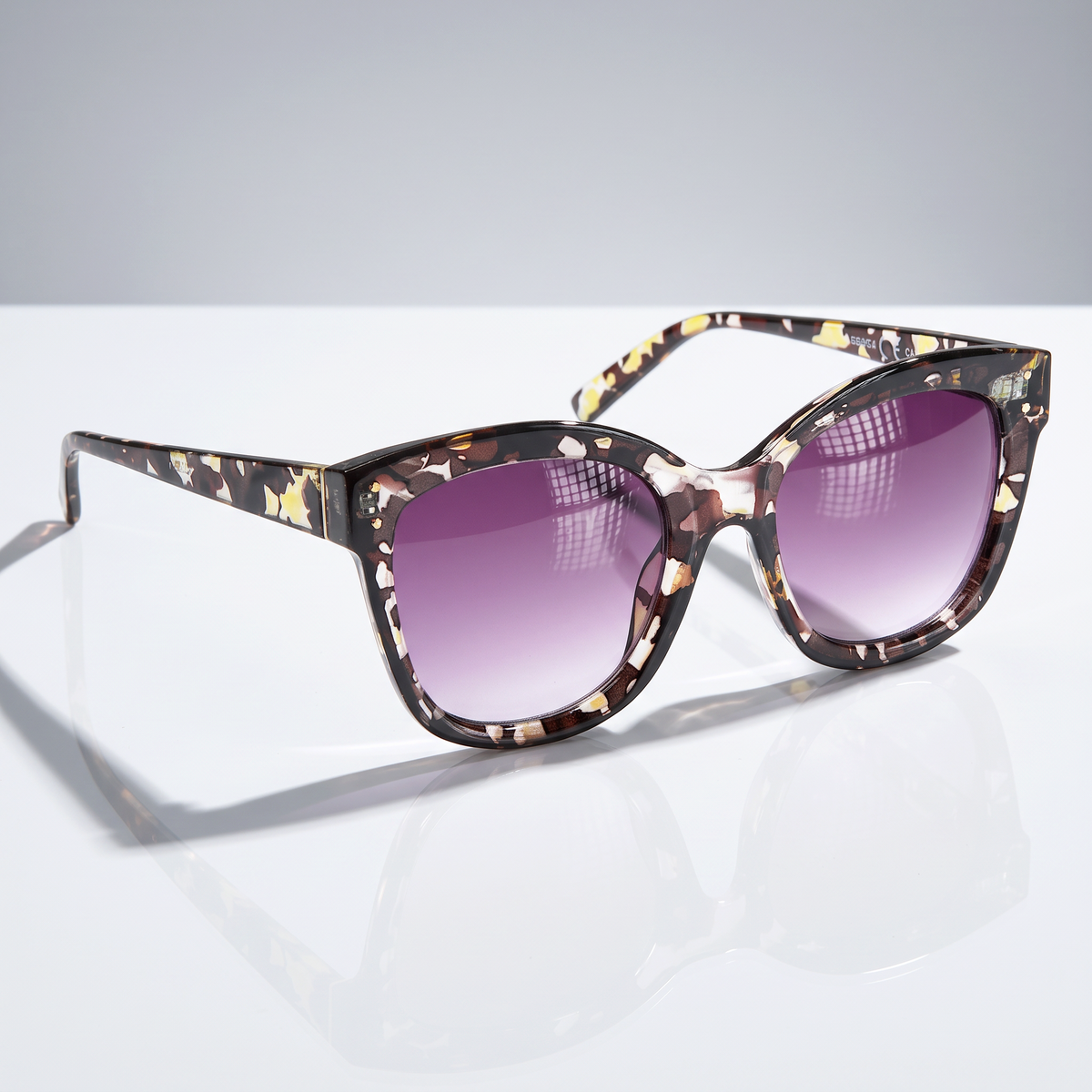 Eyelevel-UK Jessica square sunglasses with tortoiseshell frame and purple gradient lenses on a reflective surface