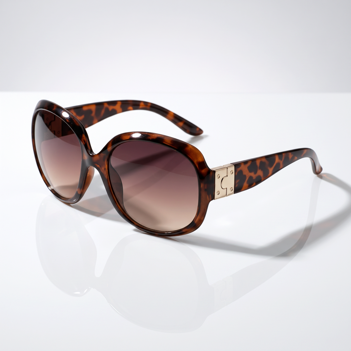 Eyelevel-UK Lucy oversized geometric sunglasses in brown tortoiseshell with gold accents and brown gradient lenses.