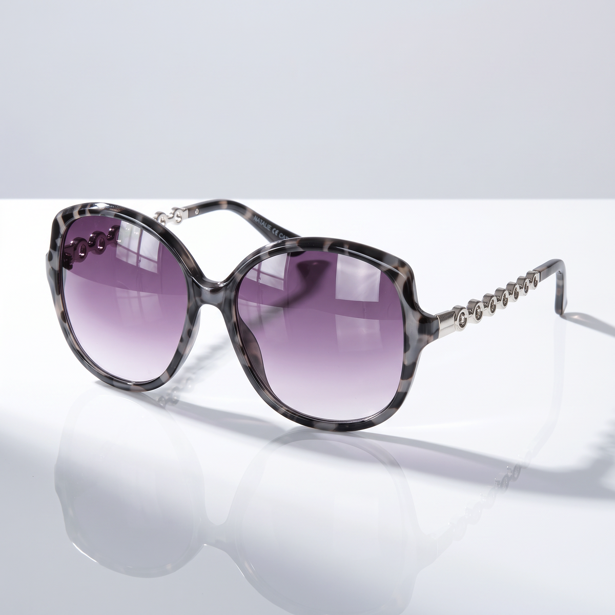 Eyelevel-UK Natalie oversized geometric sunglasses in grey tortoiseshell with silver accents and grey gradient lenses.