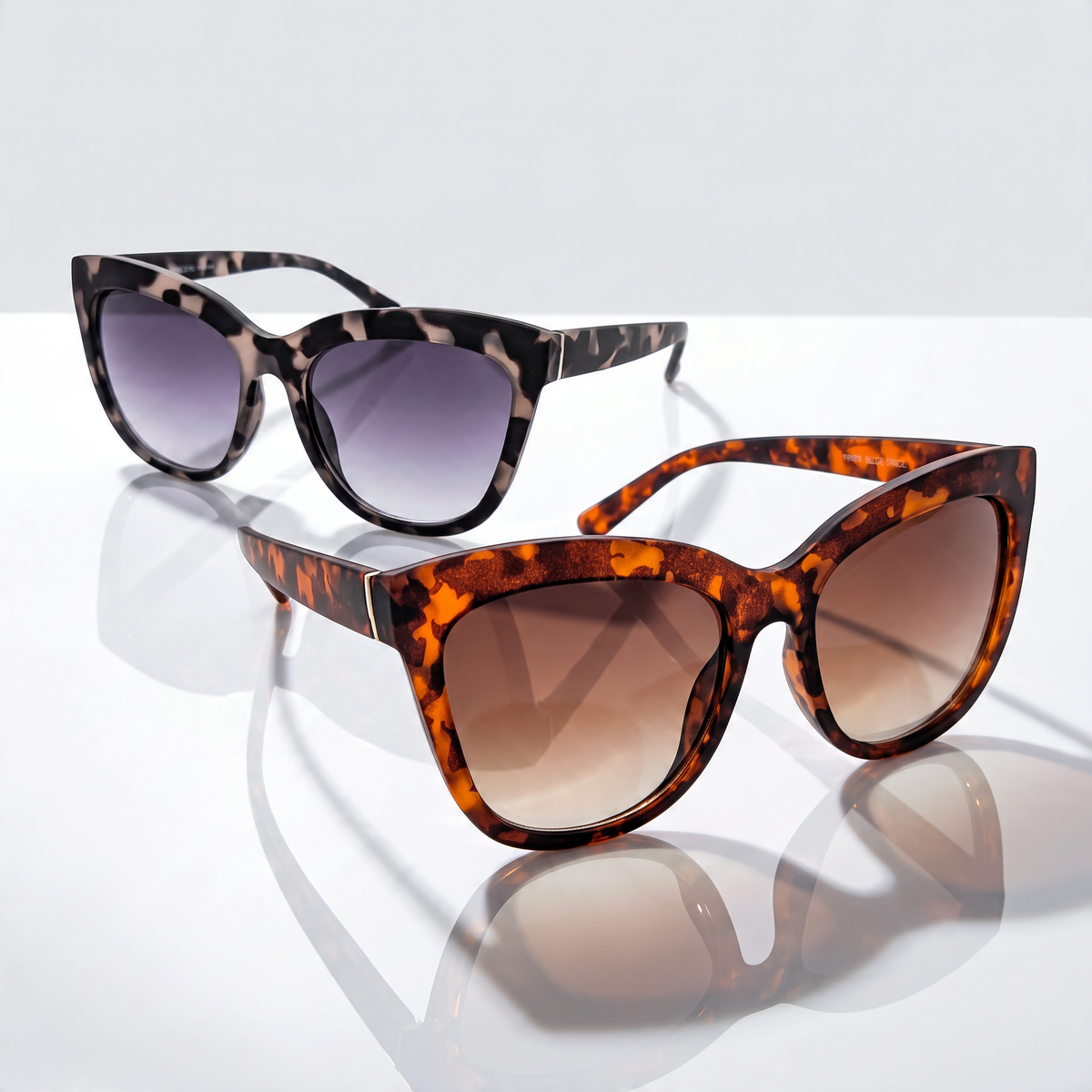 Eyelevel-UK Piper oversized cat-eye sunglasses in brown and grey tortoiseshell with gradient lenses on white surface