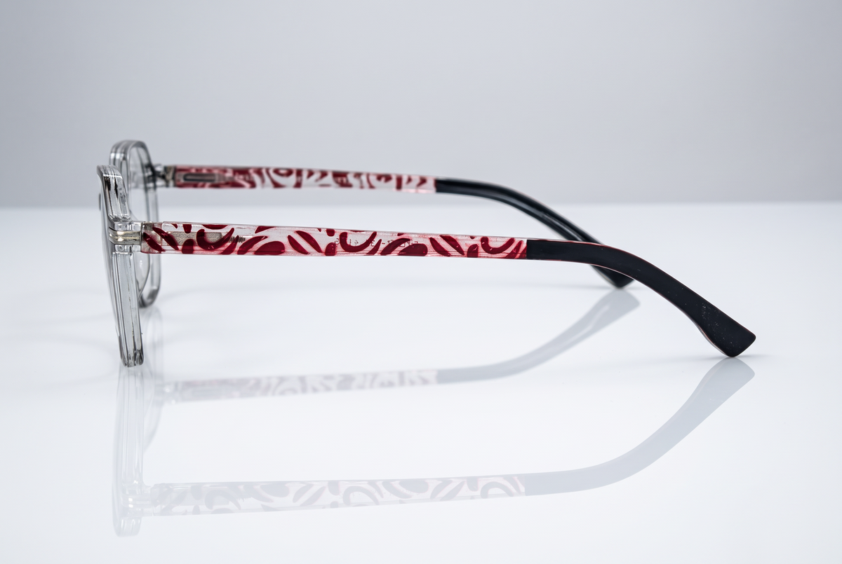 Eyelevel-UK St Kitts reading glasses with translucent grey frames and patterned red and black temples, side view.