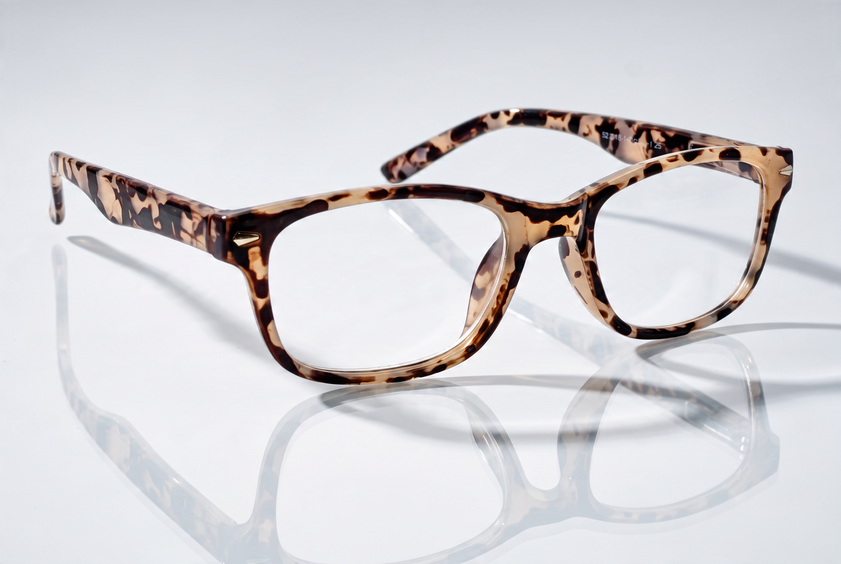 Eyelevel-UK Zante reading glasses with a brown and beige tortoiseshell square plastic frame on a reflective surface