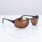 Eyelevel-UK Accelerate polarized driving sunglasses with black frames and copper lenses on a reflective white surface