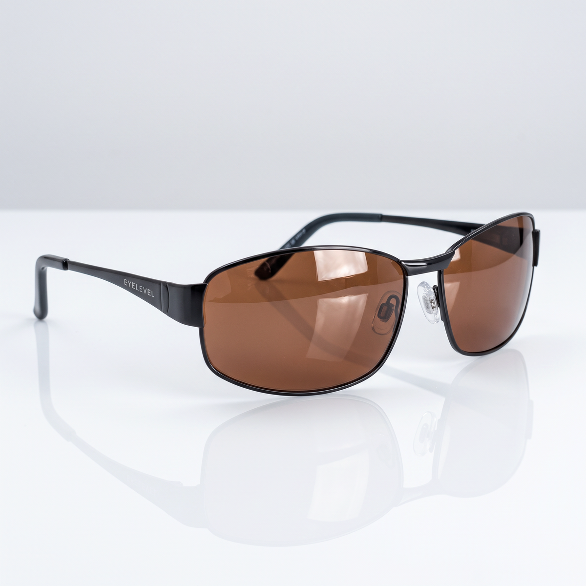 Eyelevel-UK Accelerate polarized driving sunglasses with black frames and copper lenses on a reflective white surface