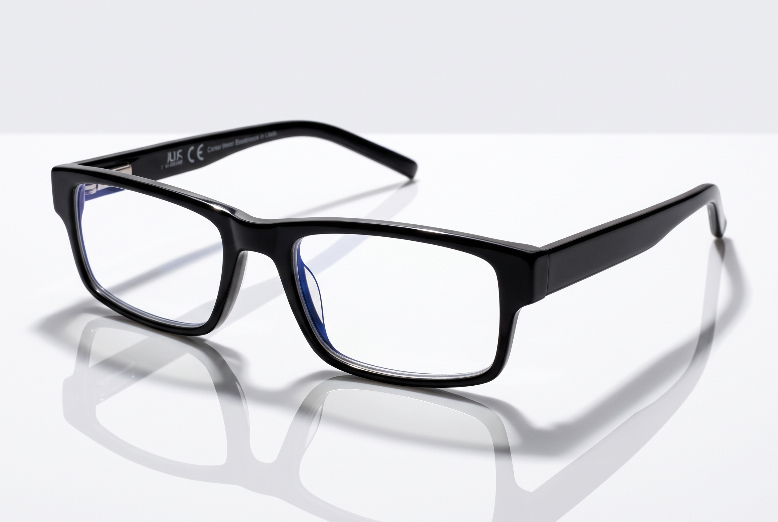 Eyelevel-UK Alfie black rectangular anti-blue light glasses with clear plano lenses on a reflective surface.