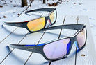 Eyelevel-UK Attack sports sunglasses with black frames and mirrored blue or red lenses. Lightweight polycarbonate with UV400 protection.