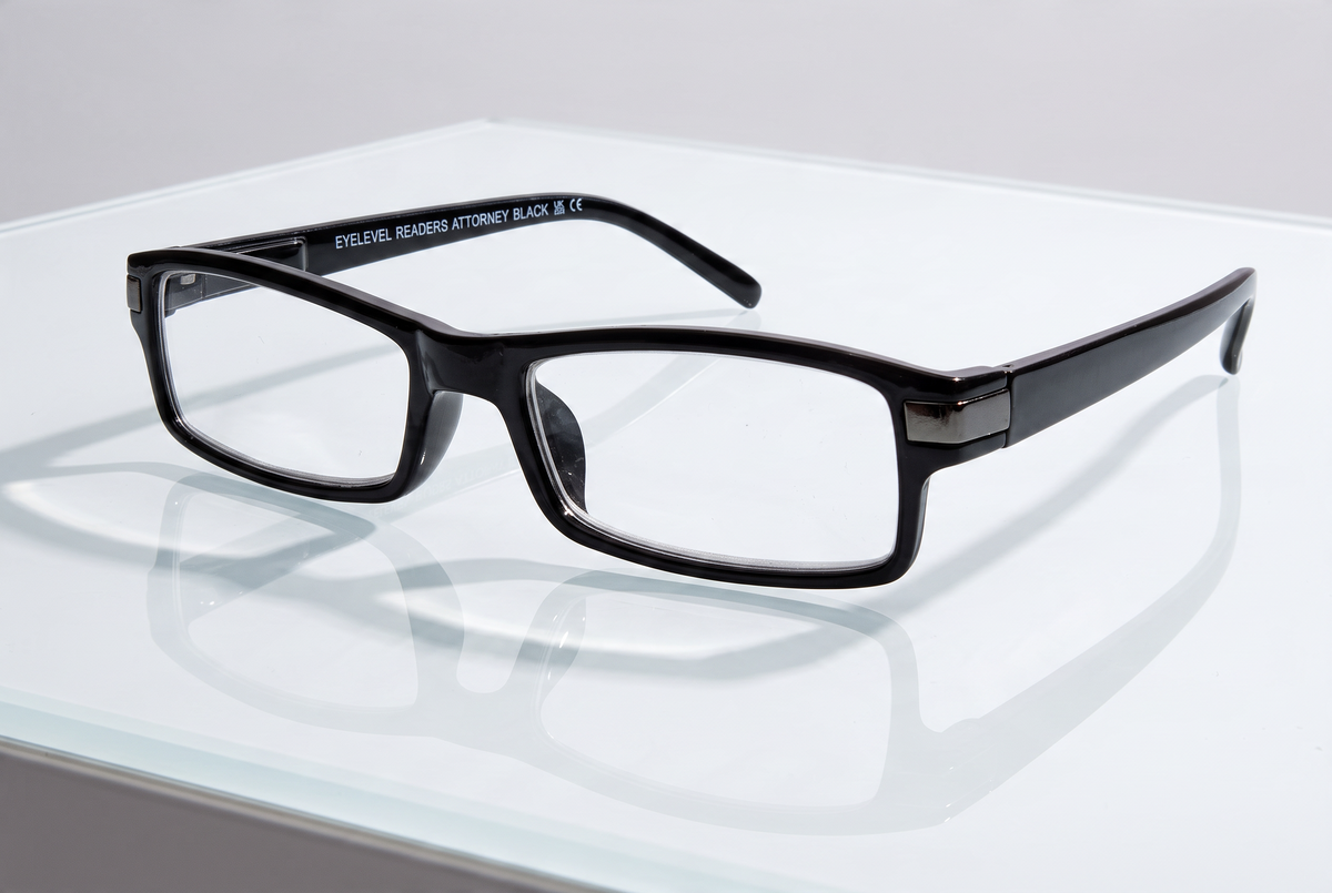 Eyelevel-UK Attorney black rectangular reading glasses with slim plastic frames on a reflective white surface