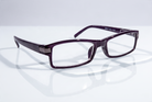 Eyelevel-UK Attorney black rectangular reading glasses with clear magnifying lenses on a reflective white surface.