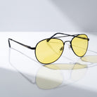 Eyelevel-UK Night Driver 1 sunglasses with black aviator frames and yellow lenses for low-light driving conditions.