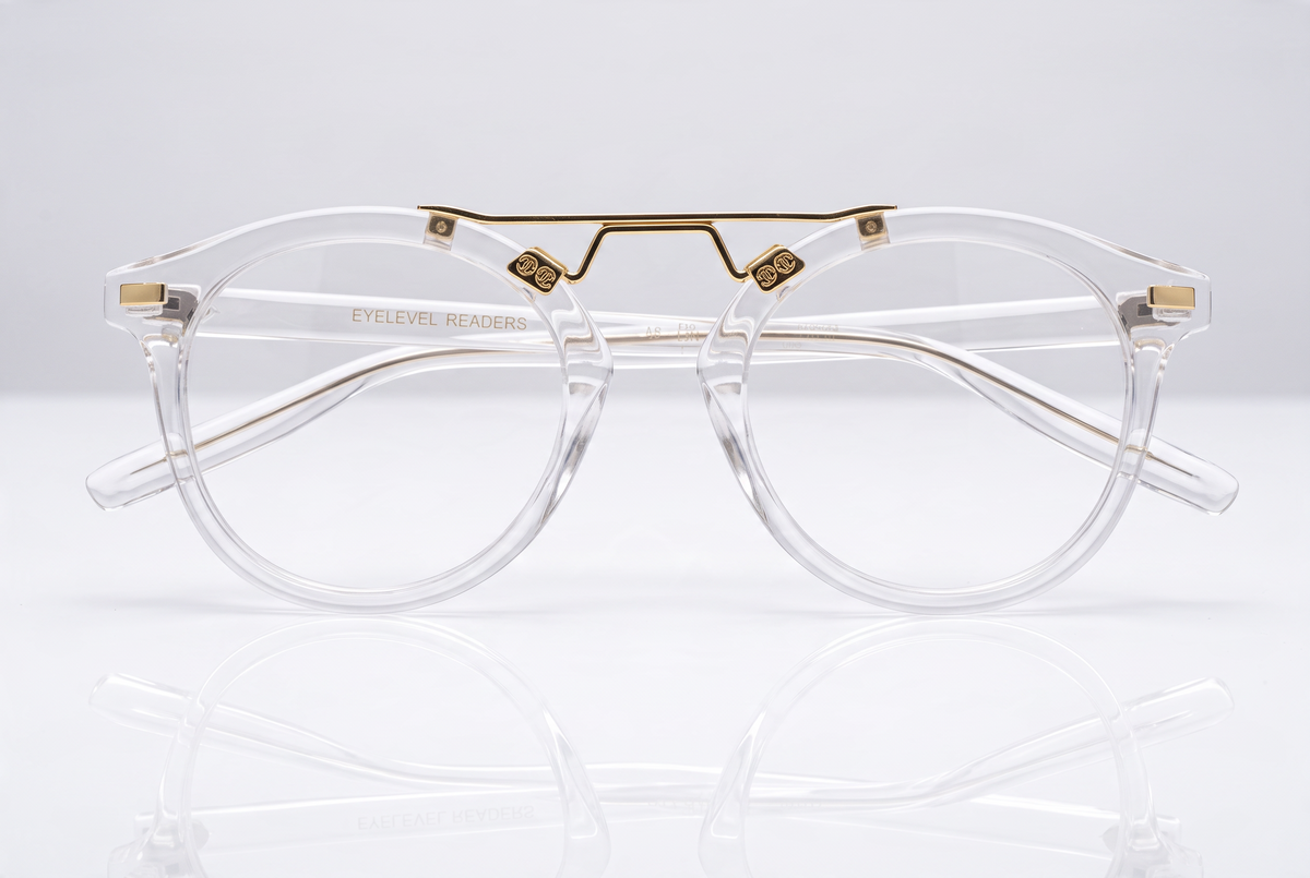 Eyelevel-UK Boston reading glasses with a transparent round frame and gold-tone bridge detailing on a white surface.