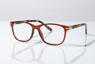 Eyelevel-UK Caracas reading glasses with a translucent brown and orange tortoiseshell rounded square plastic frame.