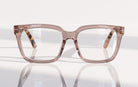 Eyelevel-UK Cayman reading glasses with a pale-pink squared frame and tortoiseshell temple details on a white surface.