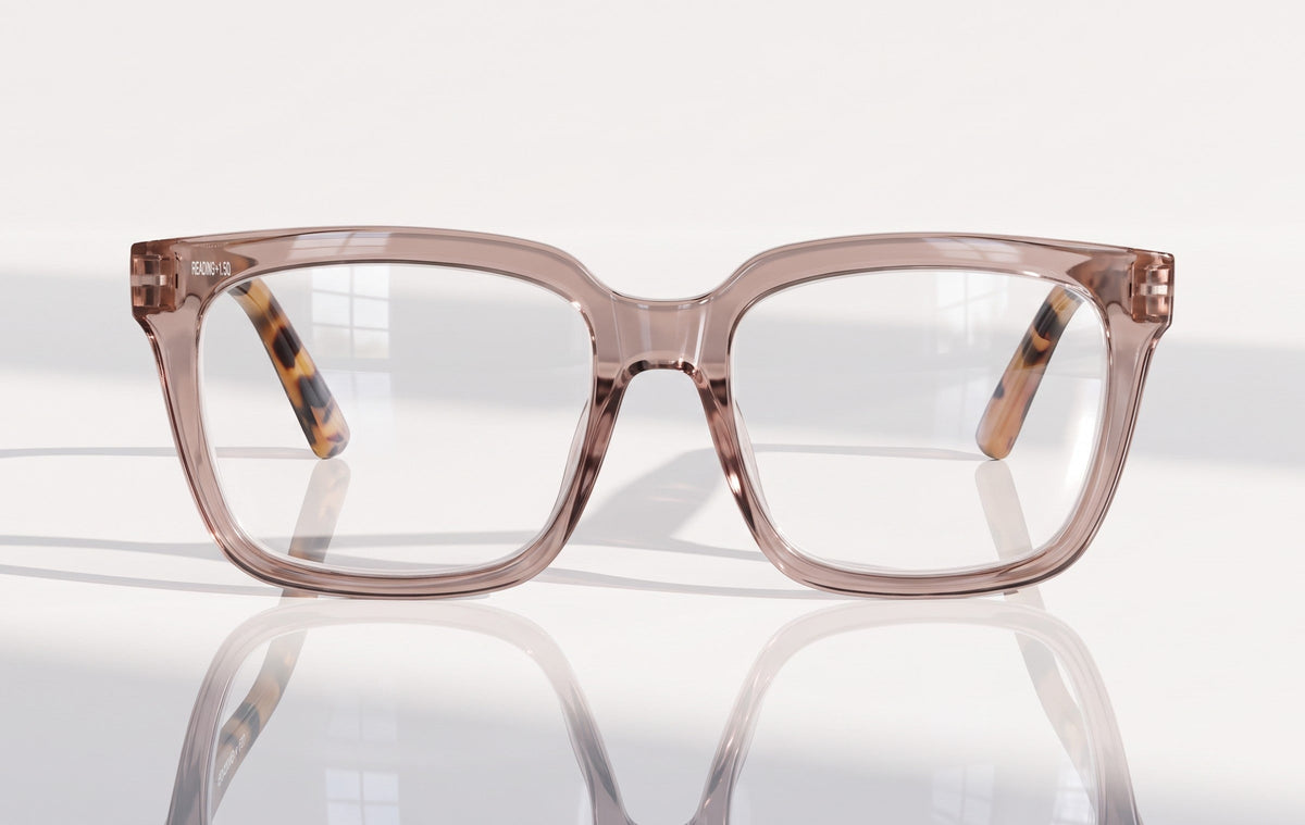 Eyelevel-UK Cayman reading glasses with a pale-pink squared frame and tortoiseshell temple details on a white surface.