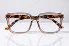 Eyelevel-UK Cayman reading glasses with a pale-pink squared frame and tortoiseshell-patterned inner detailing.