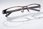 Eyelevel-UK Charles reading glasses with a bronze rectangular semi-rimless frame and clear magnifying lenses.