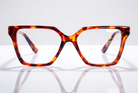 Eyelevel-UK Chile reading glasses with a brown tortoiseshell geometric frame and clear magnifying lenses.