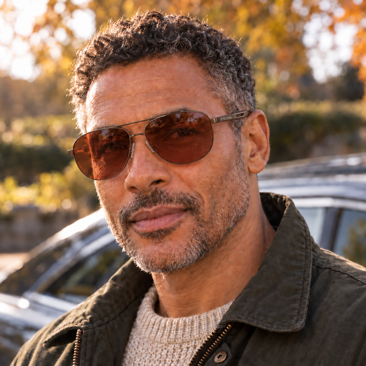 Man wearing Eyelevel-UK Circuit polarized driving sunglasses with copper lenses and a gunmetal frame outdoors.