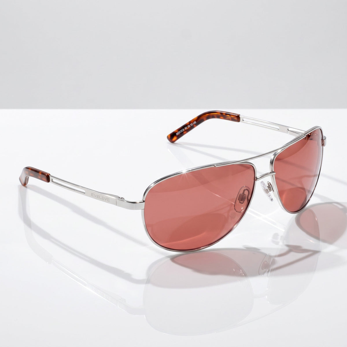 Eyelevel-UK Circuit polarized driving sunglasses with antique silver aviator frames and copper lenses on white surface