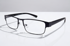 Eyelevel-UK Daniel reading glasses with a black square frame and clear magnifying lenses on a white surface