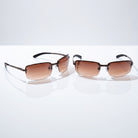 Eyelevel-UK Daytona driving sunglasses with high density brown gradient lenses and gunmetal frames on a white surface.