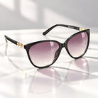 Eyelevel-UK Demi square ladies sunglasses in black and gold with grey gradient lenses and decorative stone detail.