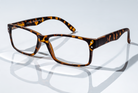 Eyelevel-UK Earl reading glasses with a brown tortoiseshell rectangular plastic frame on a reflective white surface
