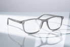 Eyelevel-UK Cambridge grey rectangular reading glasses with clear magnifying lenses on a reflective surface.