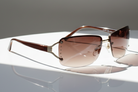 Eyelevel-UK Helena semi-rimless ladies sunglasses with gold frame, brown tinted lenses, and decorative stone accents.