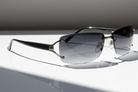 Eyelevel-UK Helena semi-rimless ladies sunglasses with gunmetal frame, black temples, and grey tinted UV400 lenses.