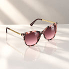 Eyelevel-UK Hope square sunglasses featuring a floral black and silver frame with soft grey gradient lenses.
