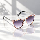 Eyelevel-UK Hope square sunglasses in tortoiseshell and silver with grey gradient lenses on a reflective surface