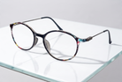 Eyelevel-UK Idaho reading glasses featuring a round, multi-coloured patterned frame with slim metal temples.