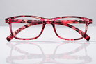 Eyelevel-UK Jamaica reading glasses featuring a pink and multicolour square plastic frame with clear magnifying lenses.