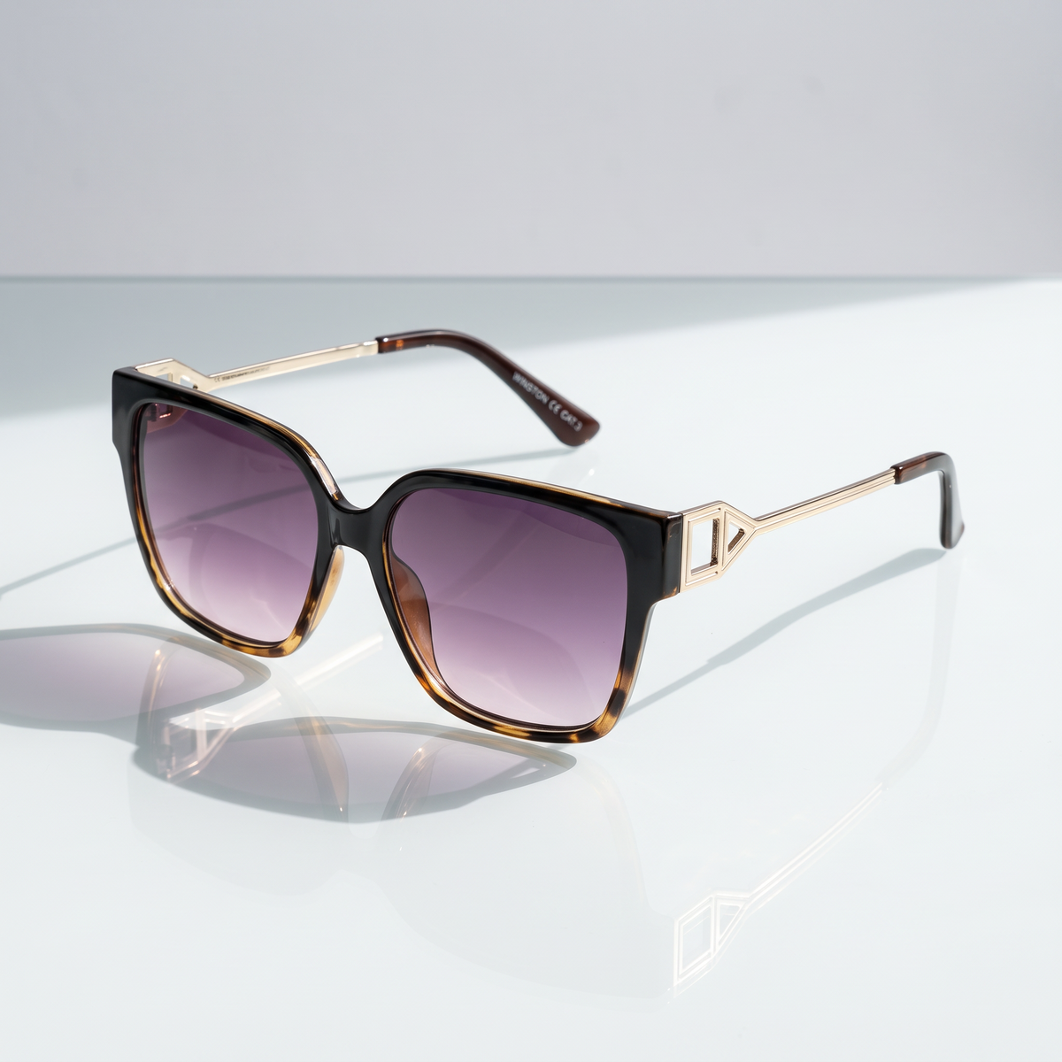Eyelevel-UK Kristen square sunglasses with black and tortoiseshell frame, silver temples, and grey gradient lenses.
