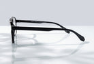 Eyelevel-UK Lancaster black square reading glasses shown from a side profile view on a reflective surface.