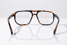 Eyelevel-UK Lancaster brown tortoiseshell square reading glasses with clear lenses on a reflective white surface
