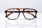 Eyelevel-UK Lancaster brown tortoiseshell square reading glasses with a double bridge design on a reflective surface.