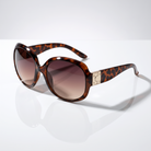 Eyelevel-UK Lucy oversized geometric sunglasses in brown tortoiseshell with gold accents and brown gradient lenses.