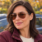 Woman wearing Eyelevel-UK Monte Carlo polarized driving sunglasses with gunmetal frames and copper lenses outdoors.