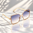 Eyelevel-UK Mya oversized geometric sunglasses with rose gold frame and beige arms featuring grey gradient lenses