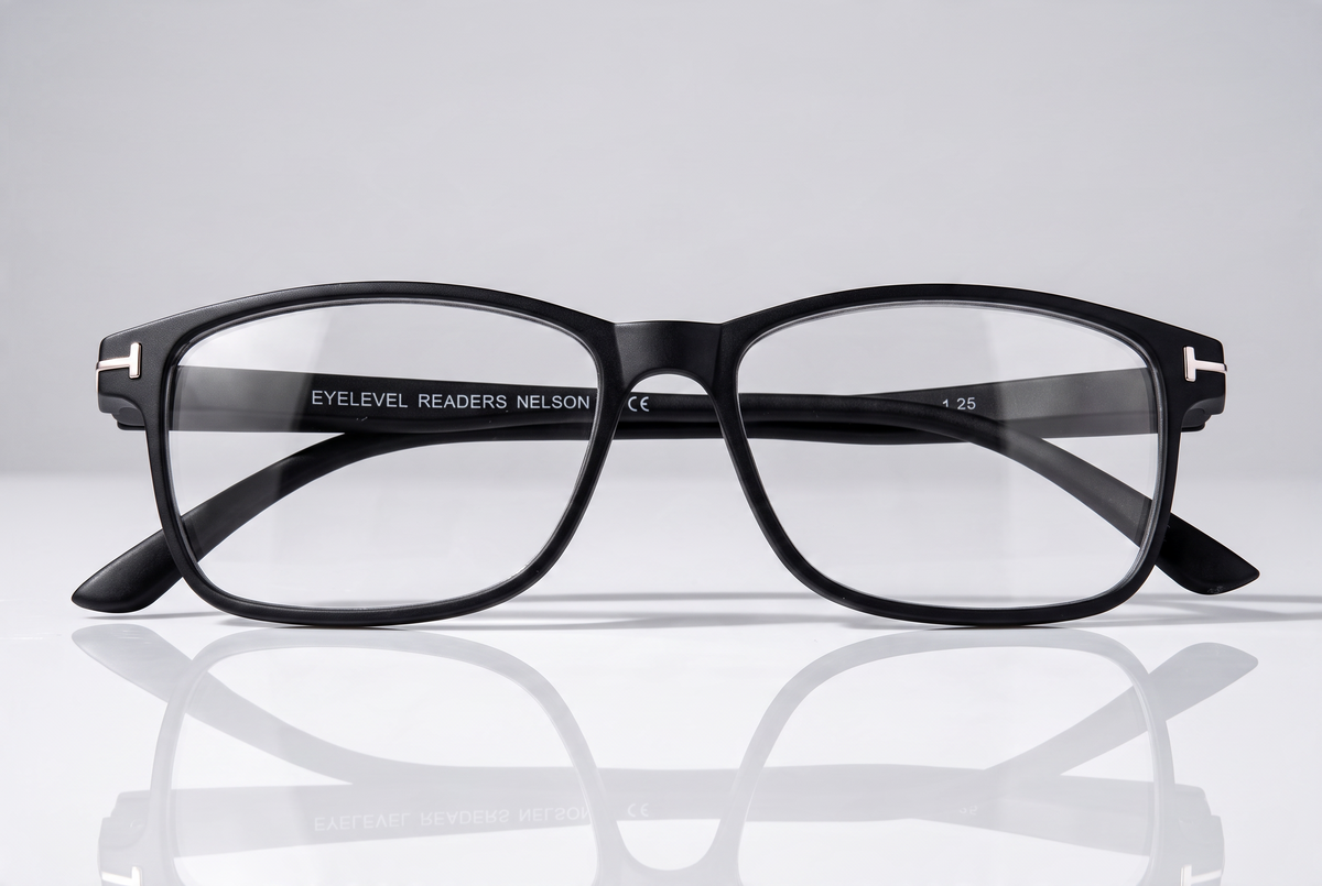 Eyelevel-UK Nelson reading glasses with a black square plastic frame and clear magnifying lenses on a white surface.