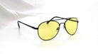 Eyelevel-UK Night Driver 1 sunglasses featuring a black metal aviator frame and yellow lenses for low-light driving.
