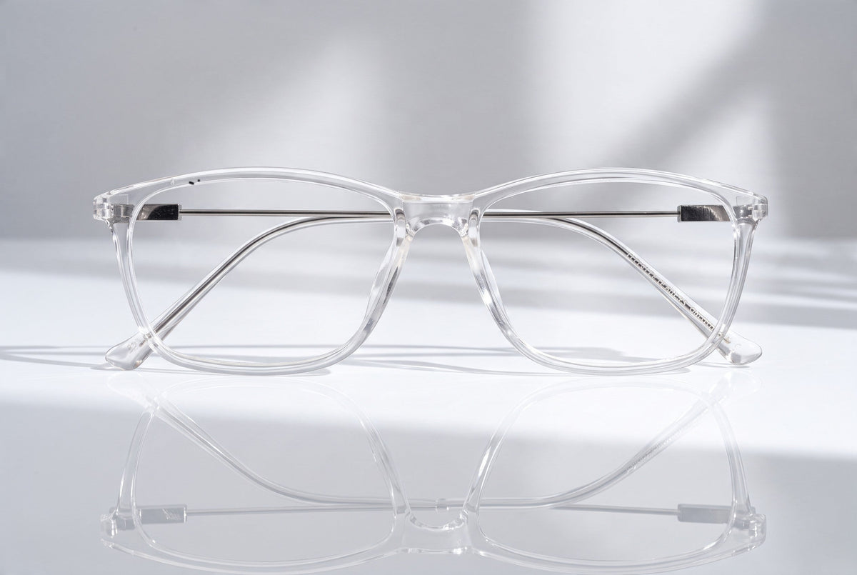 Eyelevel-UK Oregon reading glasses with a transparent softly squared plastic frame on a reflective surface.