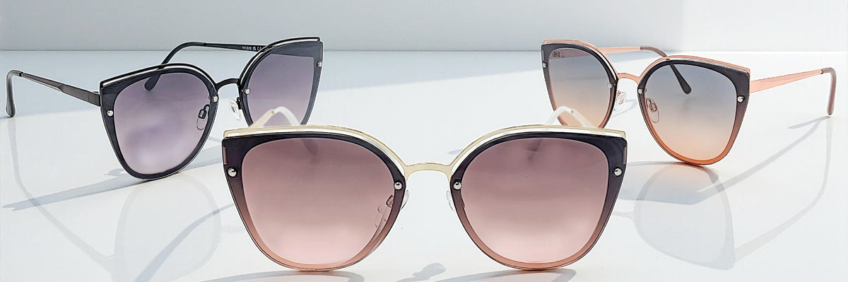 Eyelevel-UK Rosie cat-eye sunglasses in black, rose gold, and light gold with gradient lenses on a white surface.