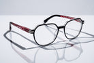 Eyelevel-UK St Kitts reading glasses with translucent grey squared frames and patterned black and red temples.