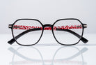 Eyelevel-UK St Kitts reading glasses with a squared translucent frame and patterned black and red temples.